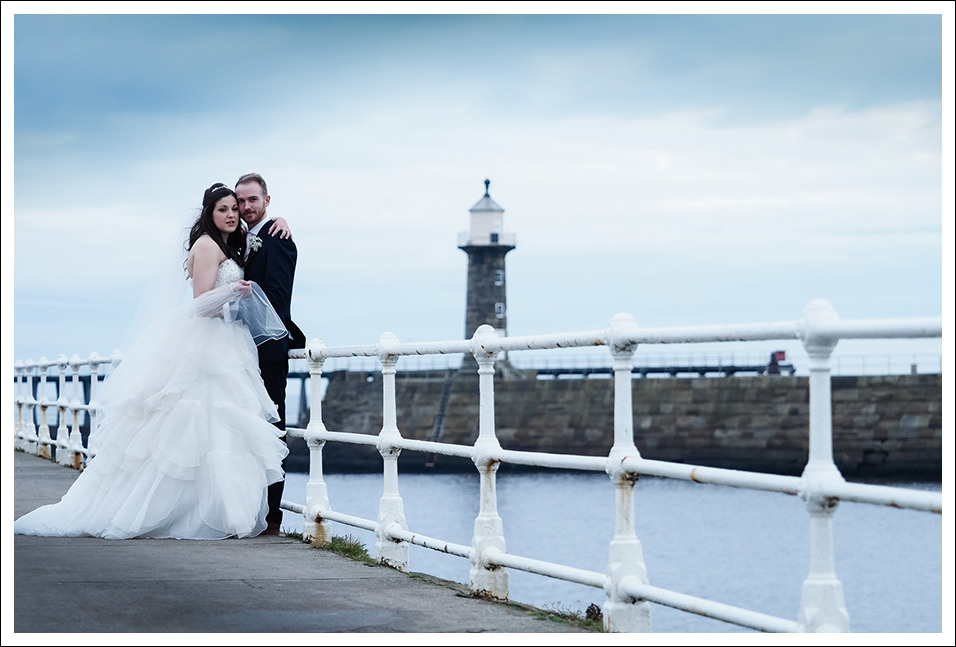 bride and groom portrait on whitby pier