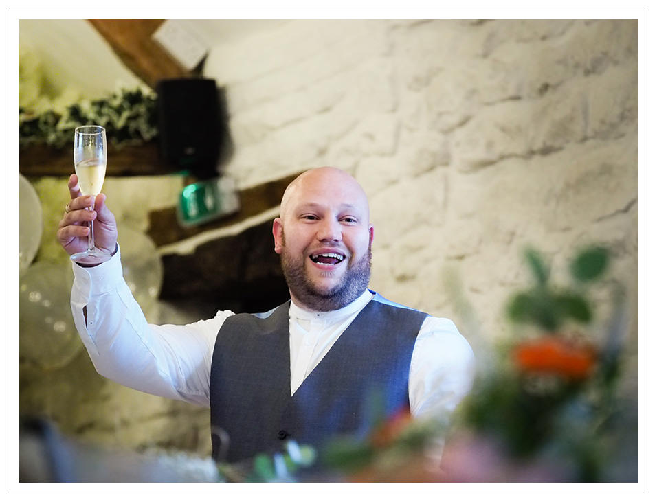 the best man toasting the bride and groom