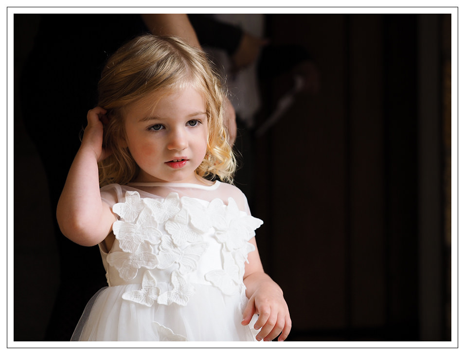 flowergirl waiting for the bride at crosbutts stables in whitby