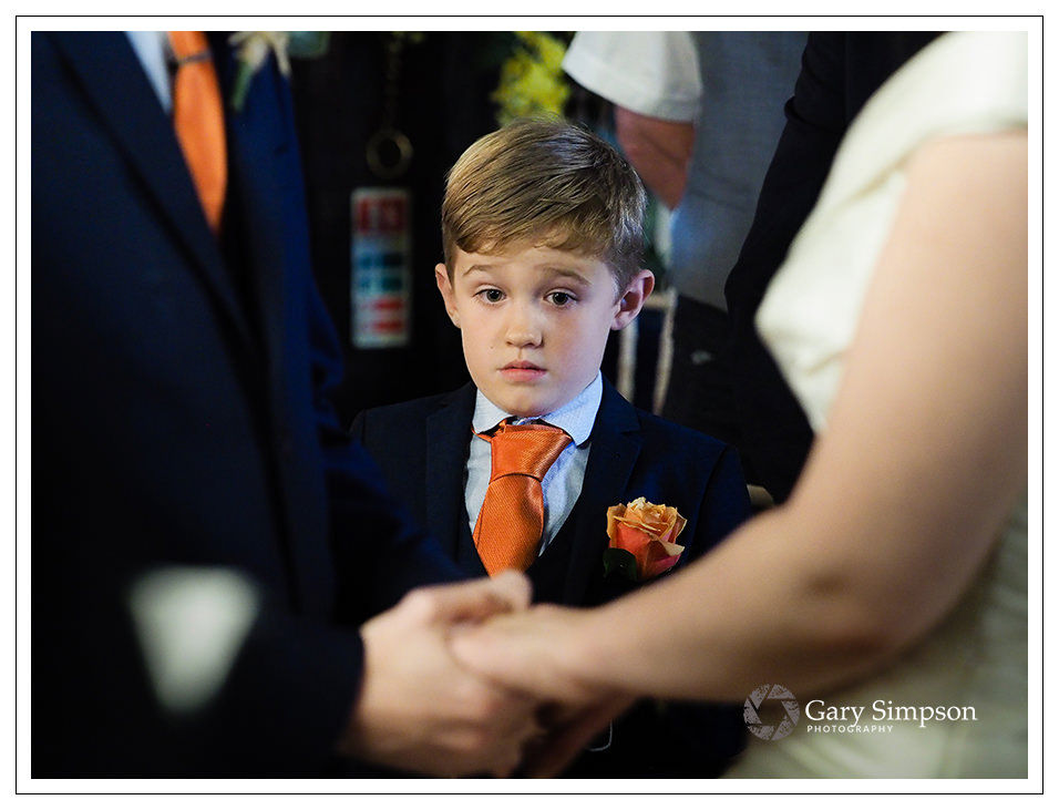 page boy at crossbutts stables during the wedding ceremony