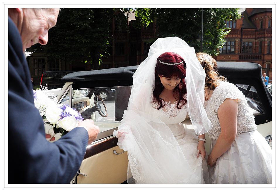 bride and brides father arriving in a vintage car at St Wilfreds catholic church in York