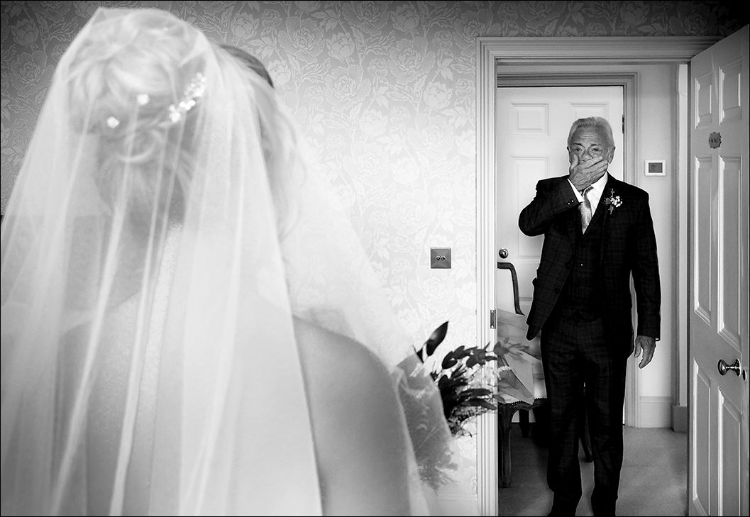 bride and her father walking to the wedding ceremony at raithwaite hall