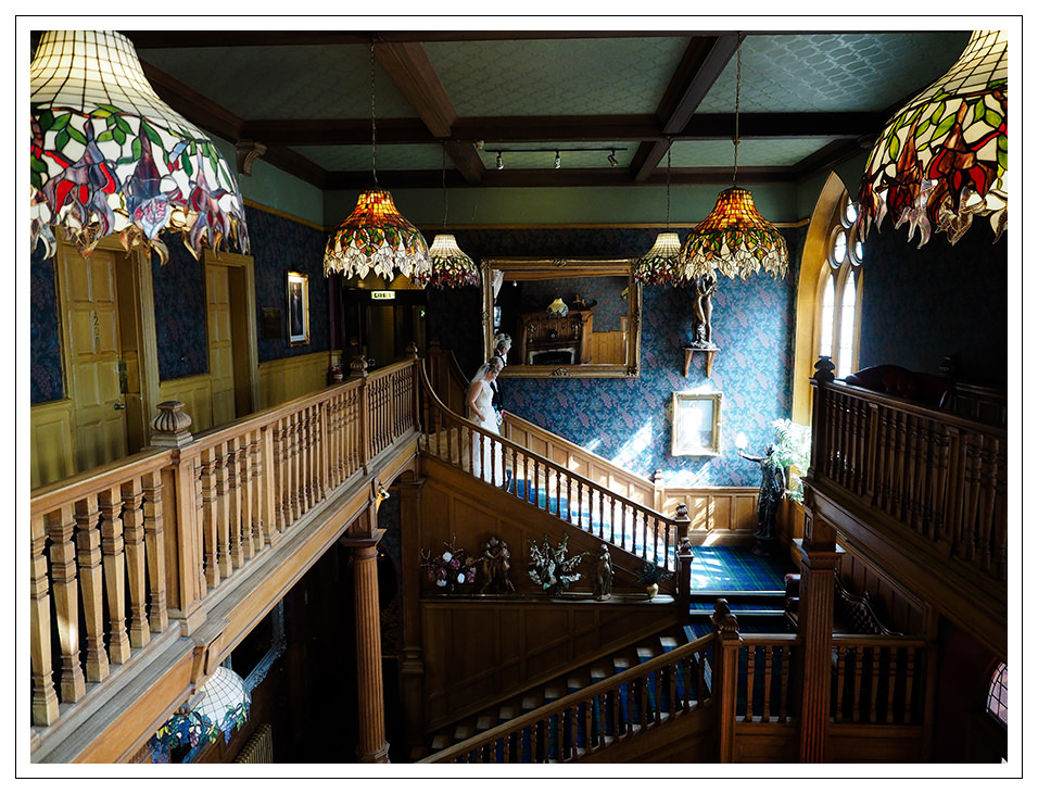 bride and brides father in the grand entrance and staircase at rushpool hall