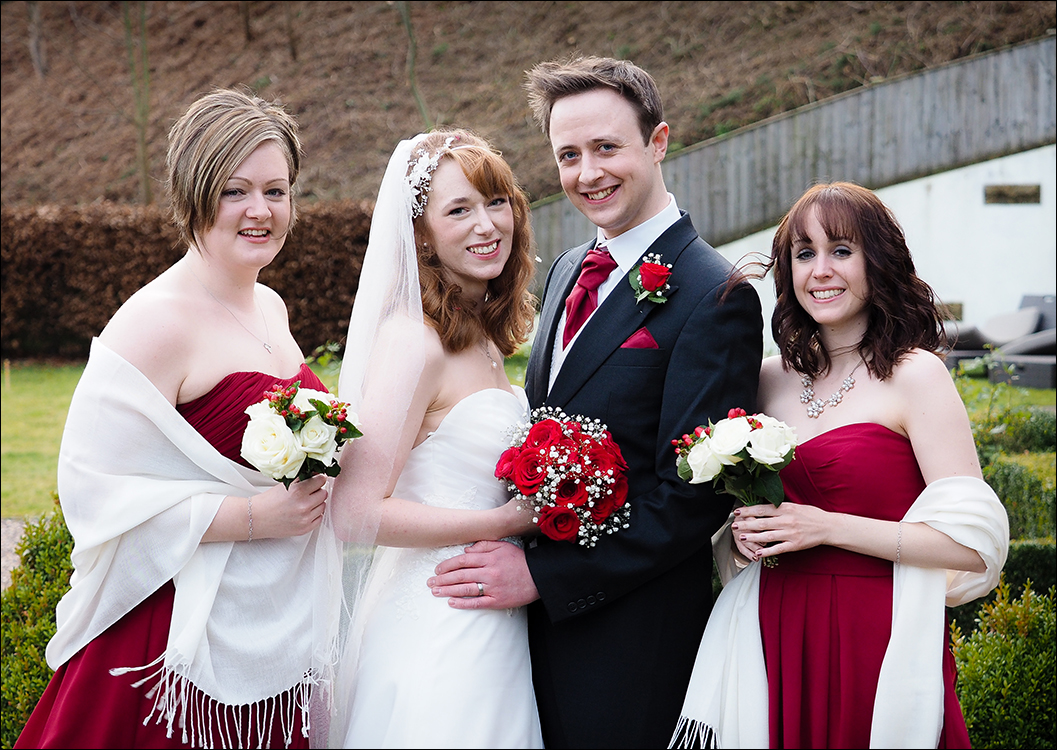 bride & groom and bridesmaids outside the Lakehouse at Raithwaite Hall