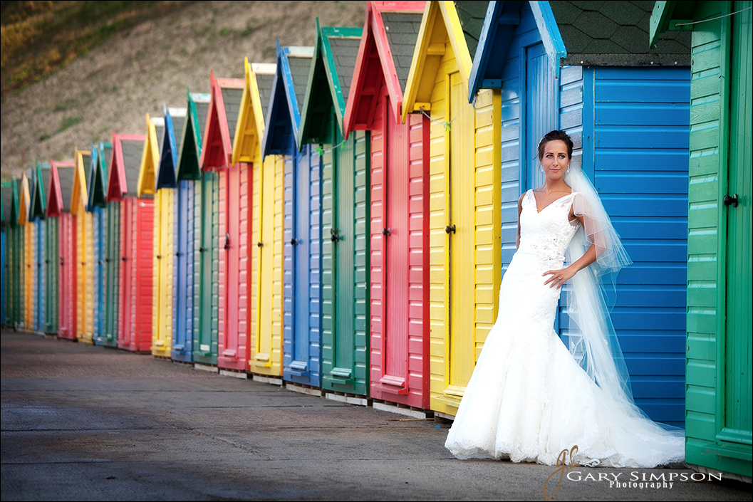 bride portrait on whitby front with the beach huts