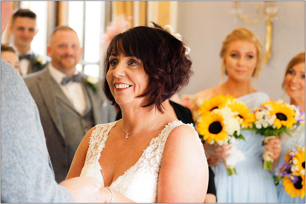 a smiling bride at oulton hall for the start of the wedding ceremony