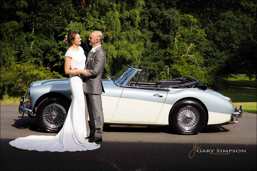 bride and groom with a austin healey at wrea hotel