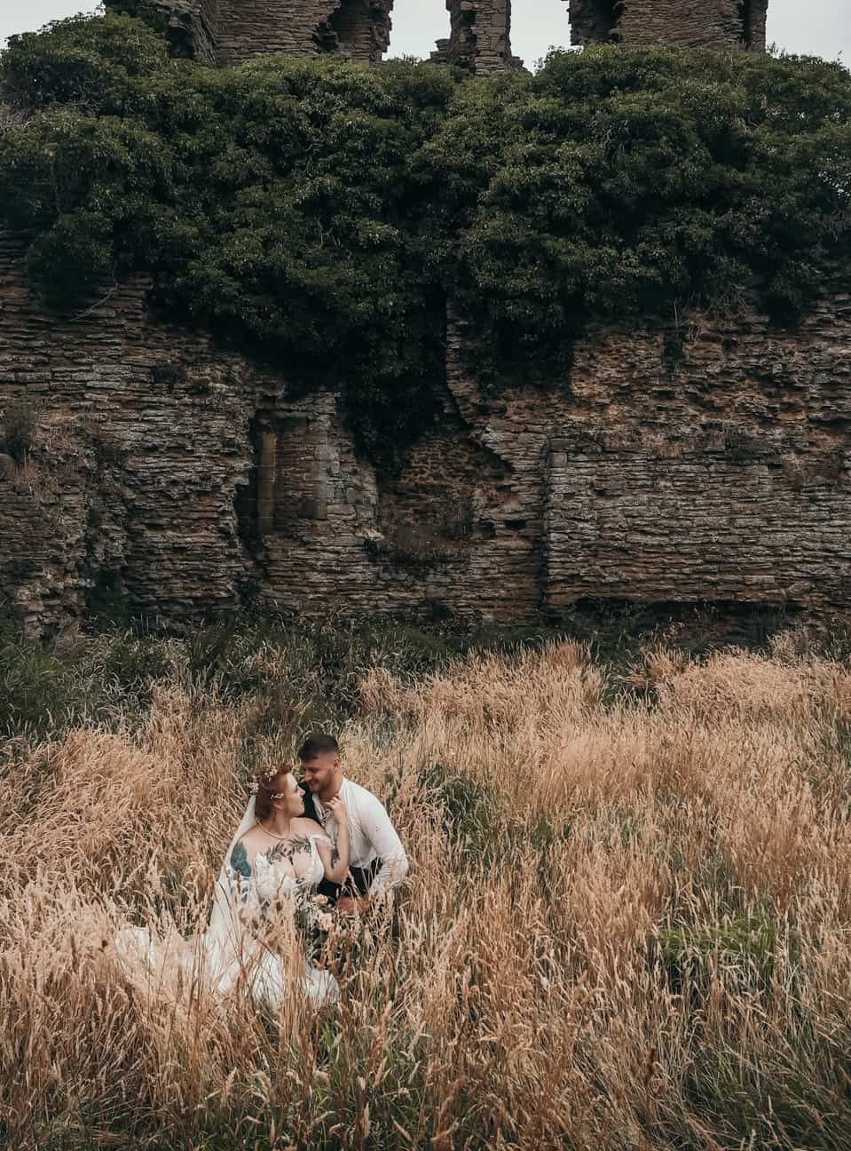 bride and groom in the gardens of sheriff hutton castle after the wedding ceremony